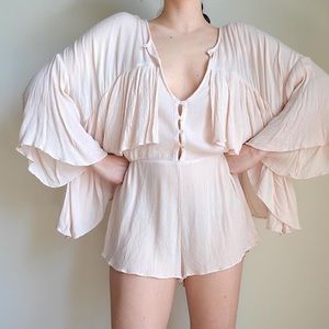 pale pink long sleeve romper from free people
labeled size small